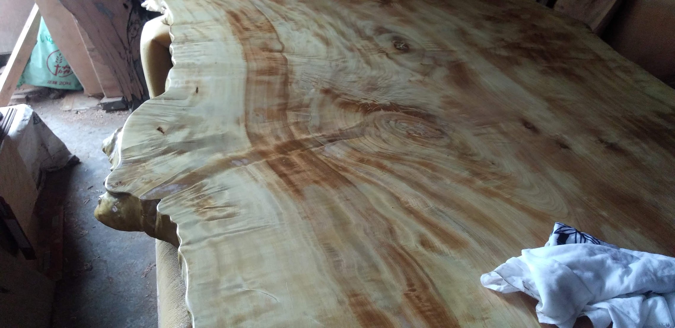 Rough-sawn tochi slab showing bandsaw marks before finishing